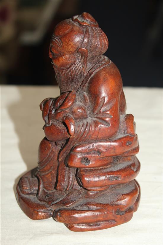 A Chinese bamboo seated figure of an immortal, 13.5cm